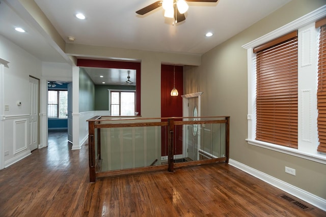 empty room with baseboards, visible vents, ceiling fan, wood finished floors, and recessed lighting