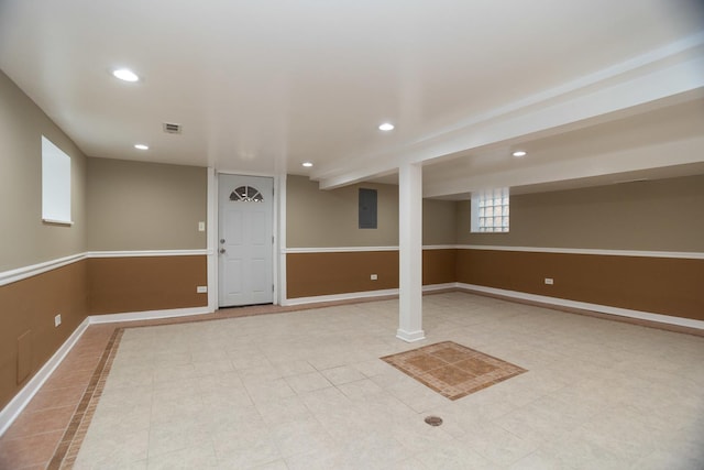 basement featuring recessed lighting, visible vents, baseboards, electric panel, and tile patterned floors