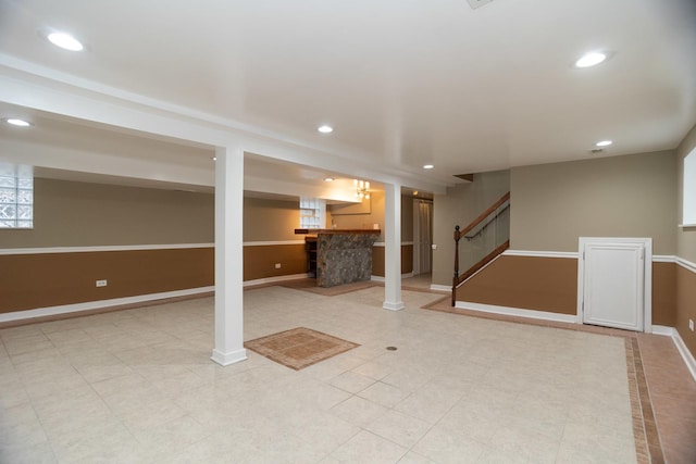 finished basement featuring baseboards, stairway, and recessed lighting