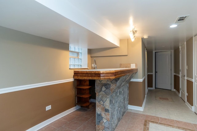 bar featuring recessed lighting, visible vents, baseboards, and tile patterned floors