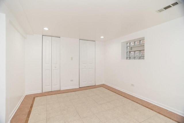 unfurnished bedroom featuring baseboards, visible vents, and recessed lighting