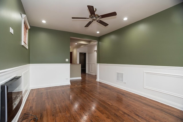 unfurnished room featuring dark wood-style floors, wine cooler, wainscoting, and recessed lighting