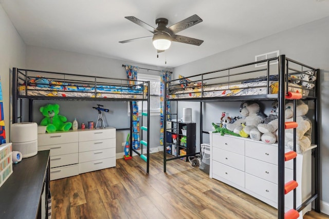 bedroom featuring wood finished floors and visible vents