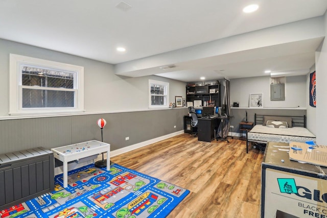 game room with recessed lighting, wood finished floors, visible vents, wainscoting, and electric panel