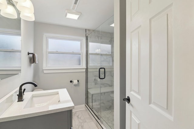 full bath featuring marble finish floor, visible vents, a stall shower, vanity, and baseboards