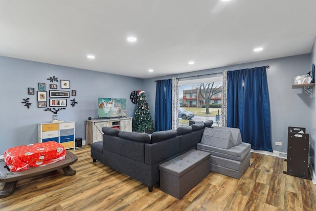 living area with recessed lighting, baseboards, and wood finished floors