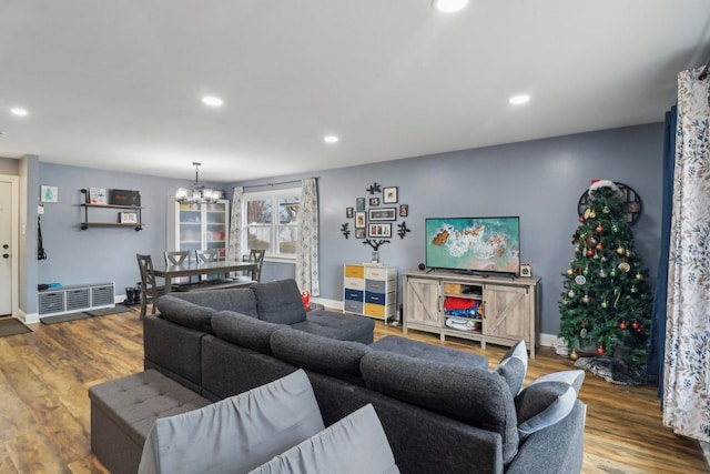 living area with a chandelier, baseboards, wood finished floors, and recessed lighting