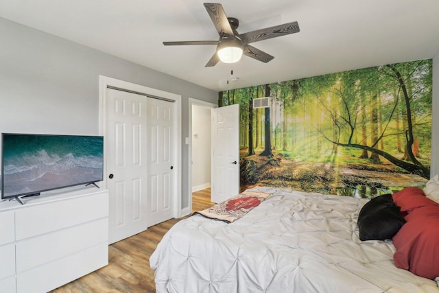 bedroom with a closet, visible vents, ceiling fan, and light wood finished floors