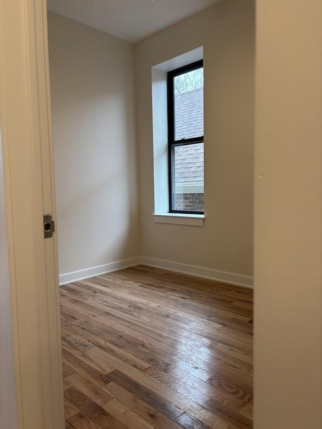 unfurnished room featuring baseboards and wood finished floors