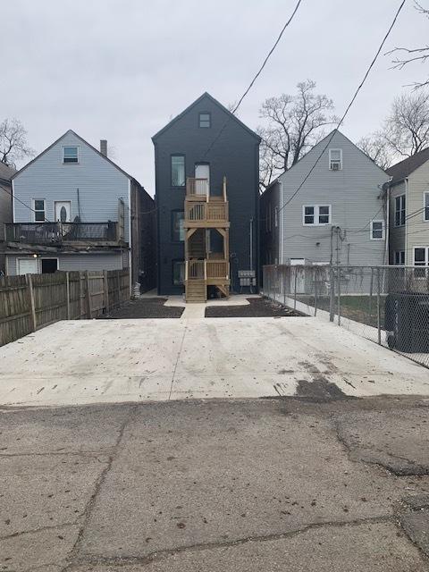 view of front of house featuring fence and a playground