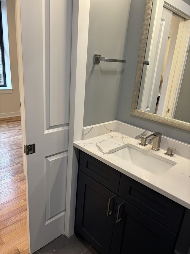 bathroom with vanity and wood finished floors