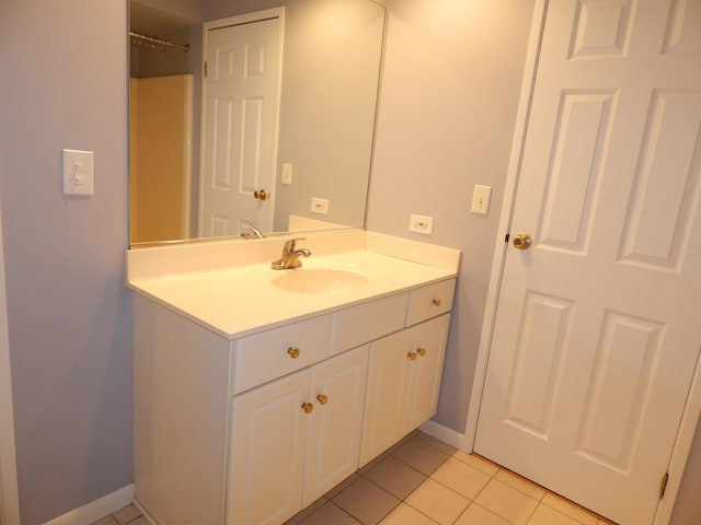 bathroom featuring vanity, tile patterned floors, and baseboards