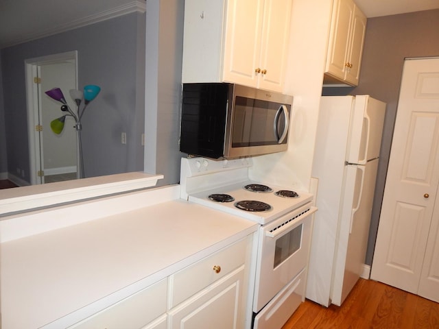 kitchen featuring light wood finished floors, white cabinets, white appliances, and light countertops