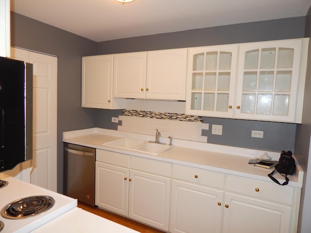 kitchen with white cabinetry, a sink, glass insert cabinets, stainless steel dishwasher, and backsplash