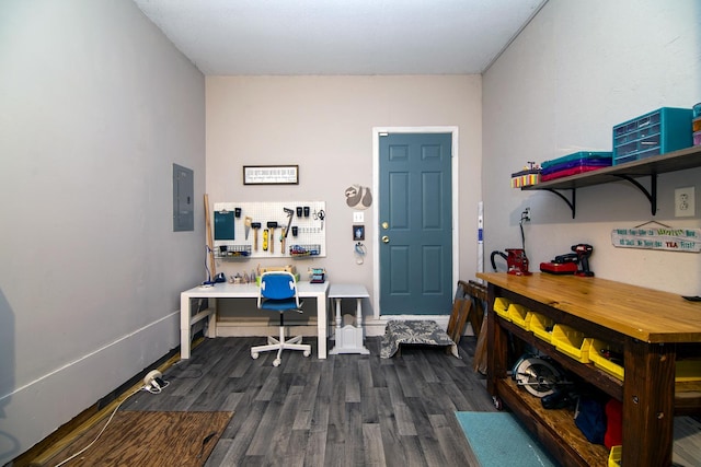 office area with dark wood-style floors, electric panel, and a workshop area