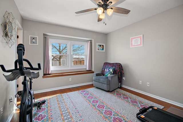 workout room with visible vents, ceiling fan, baseboards, and wood finished floors