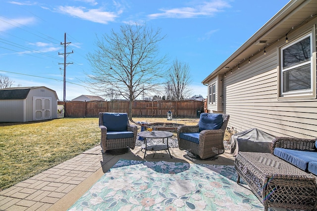 view of patio with a storage shed, an outdoor hangout area, an outbuilding, and a fenced backyard