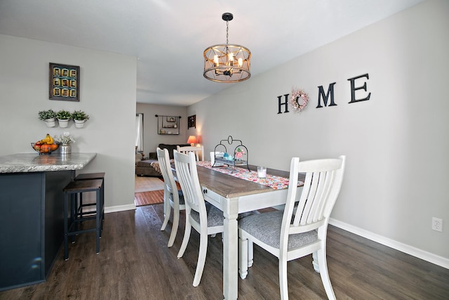 dining area with dark wood-style floors, baseboards, and an inviting chandelier