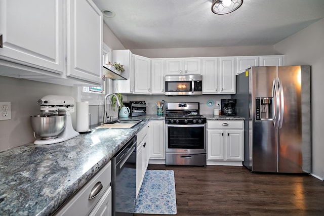 kitchen featuring stainless steel appliances, dark wood-type flooring, a sink, and white cabinetry