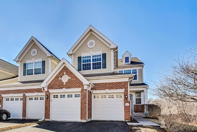 view of front of property featuring driveway and brick siding