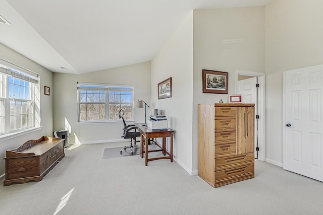 office space featuring lofted ceiling, carpet floors, and baseboards