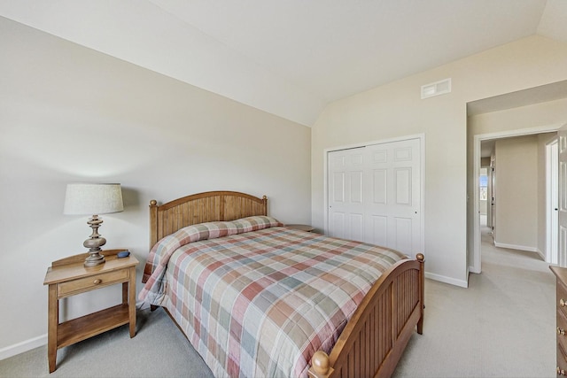 bedroom with visible vents, vaulted ceiling, light carpet, and baseboards