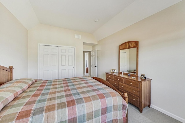 bedroom featuring lofted ceiling, visible vents, a closet, and light colored carpet