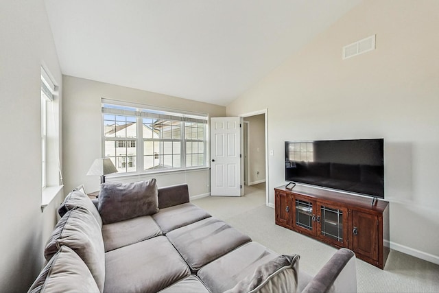 carpeted living room featuring visible vents, vaulted ceiling, and baseboards