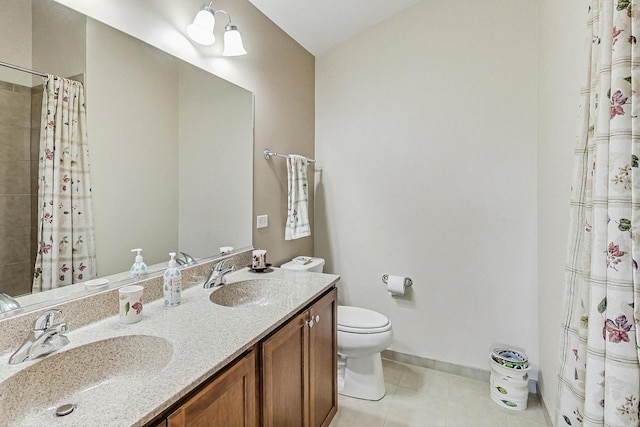 bathroom with tile patterned flooring, baseboards, a sink, and toilet