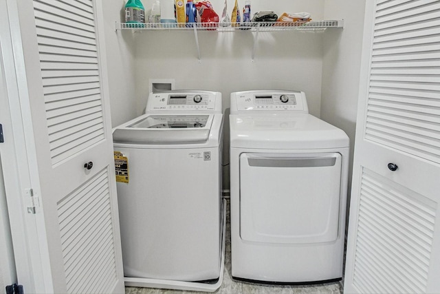 laundry room with laundry area and washer and clothes dryer