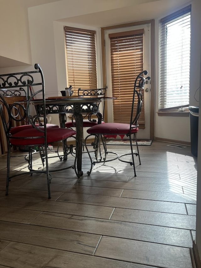 dining room featuring baseboards and wood finished floors