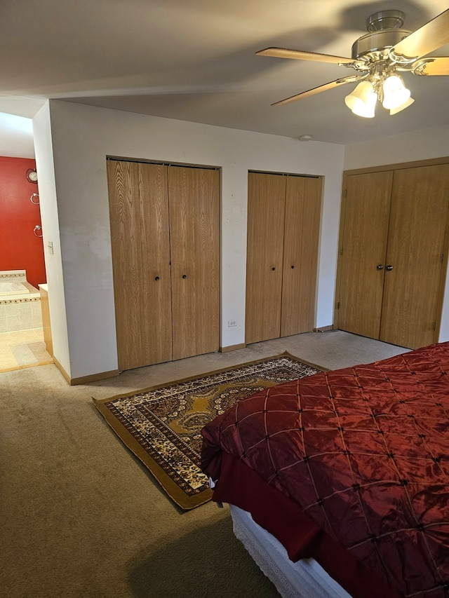 carpeted bedroom featuring ceiling fan, baseboards, and multiple closets