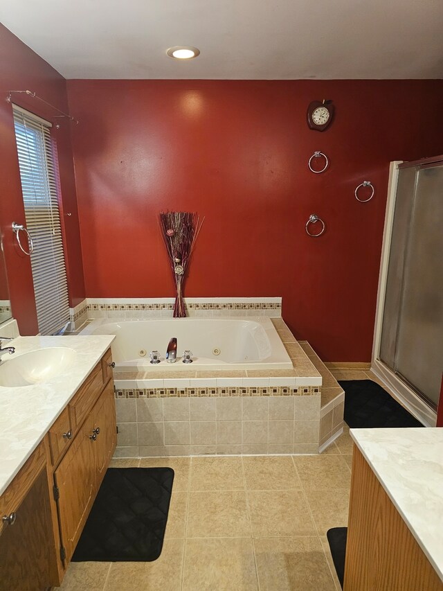 full bath with a jetted tub, a stall shower, vanity, and tile patterned floors