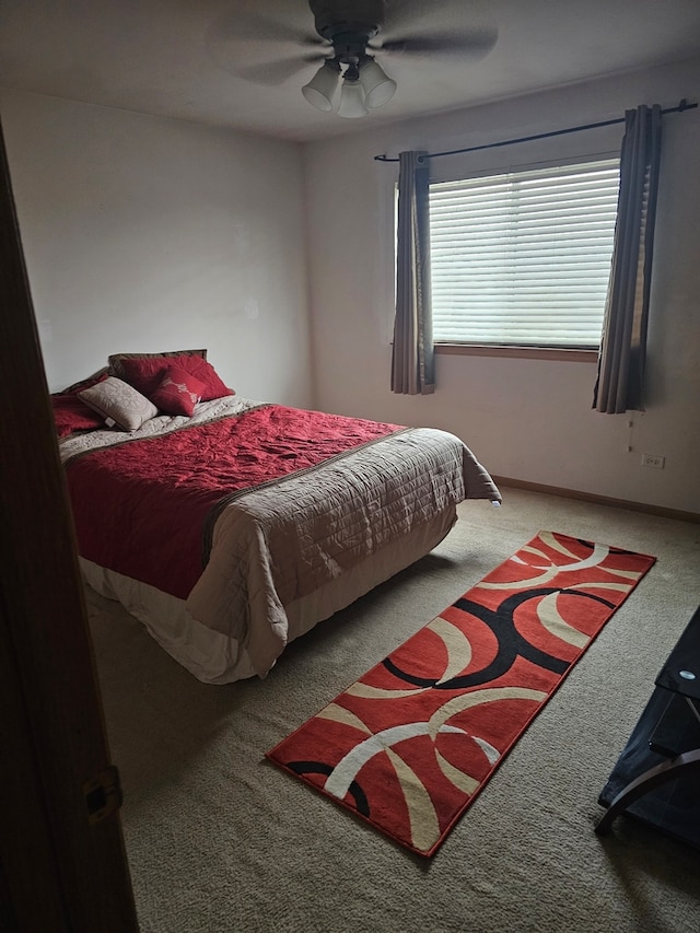 bedroom with ceiling fan, carpet, and baseboards