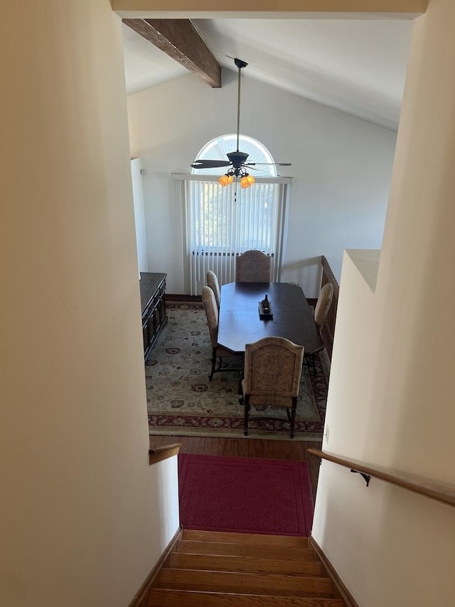 dining room with lofted ceiling with beams, wood finished floors, and a ceiling fan