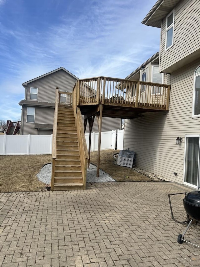 view of patio / terrace featuring stairs, fence, and a deck