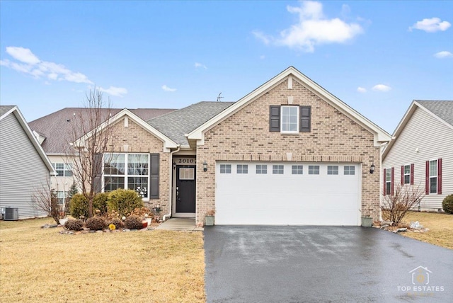 view of front of home with driveway, roof with shingles, a front lawn, and brick siding