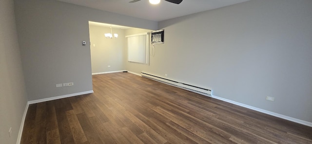 unfurnished room featuring baseboards, baseboard heating, dark wood-style flooring, and ceiling fan with notable chandelier