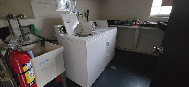 laundry area with washer and clothes dryer and a sink