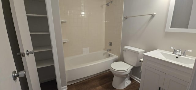 bathroom featuring toilet, shower / bath combination, wood finished floors, and vanity