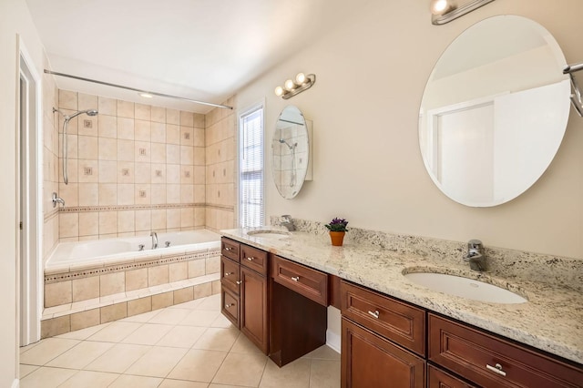 full bath with tile patterned flooring, a sink, tiled shower / bath, and double vanity