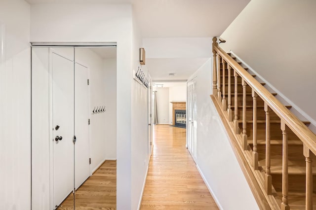 hallway featuring light wood finished floors and stairs