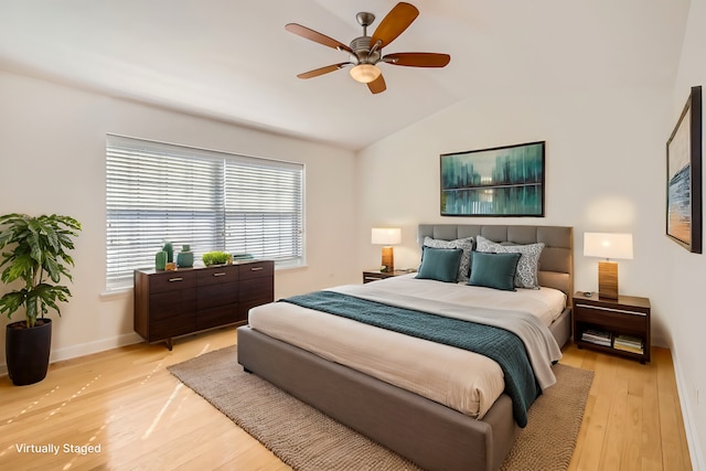 bedroom with baseboards, vaulted ceiling, light wood finished floors, and ceiling fan