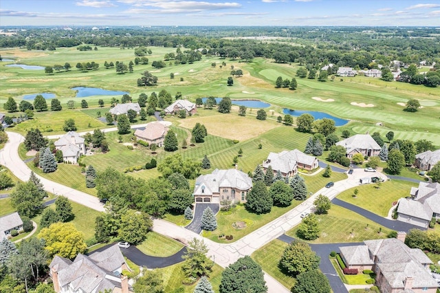 birds eye view of property featuring a water view, view of golf course, and a residential view