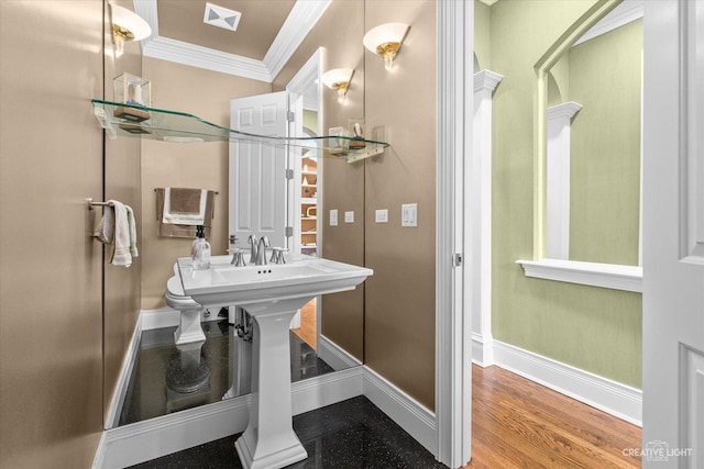 bathroom featuring visible vents, baseboards, crown molding, and wood finished floors