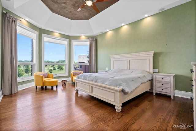 bedroom featuring a ceiling fan, dark wood-style flooring, and baseboards