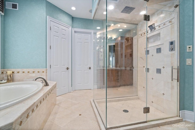 bathroom featuring a bath, a stall shower, and visible vents