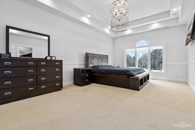 bedroom with recessed lighting, baseboards, a tray ceiling, and light colored carpet