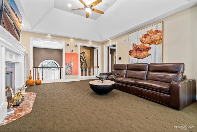 living room featuring carpet, a fireplace, visible vents, a ceiling fan, and high vaulted ceiling