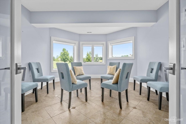 sitting room with baseboards and tile patterned floors